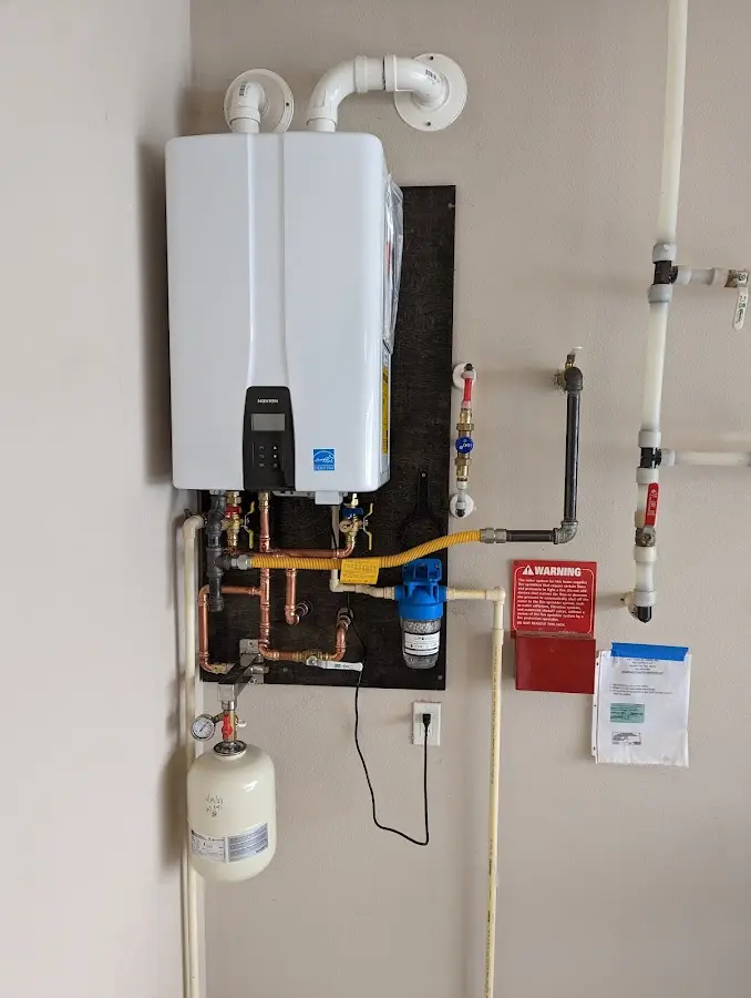 Professional plumber installing copper piping in a Calhoun home